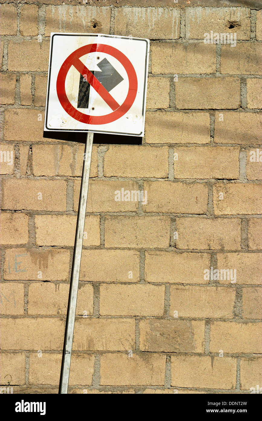 Traffic sign, no right turn in front of brick wall. Cabo San Lucas, Mexico Stock Photo