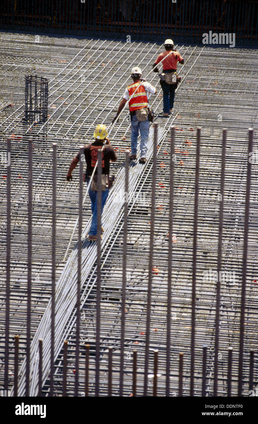 Worker carrying rebar hires stock photography and images Alamy