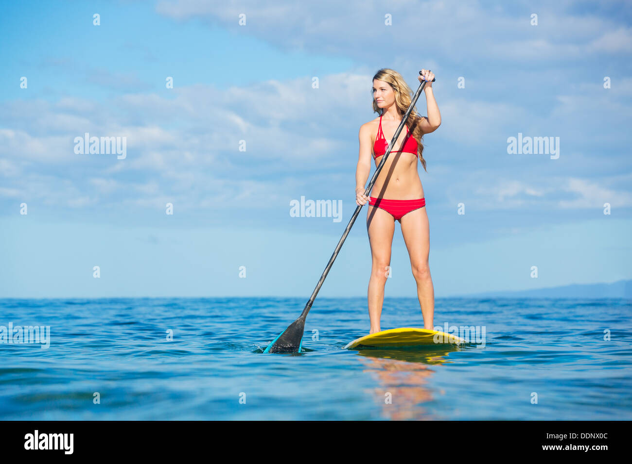 Attractive Woman on Stand Up Paddle Board, SUP, Tropical Blue Ocean, Hawaii Stock Photo