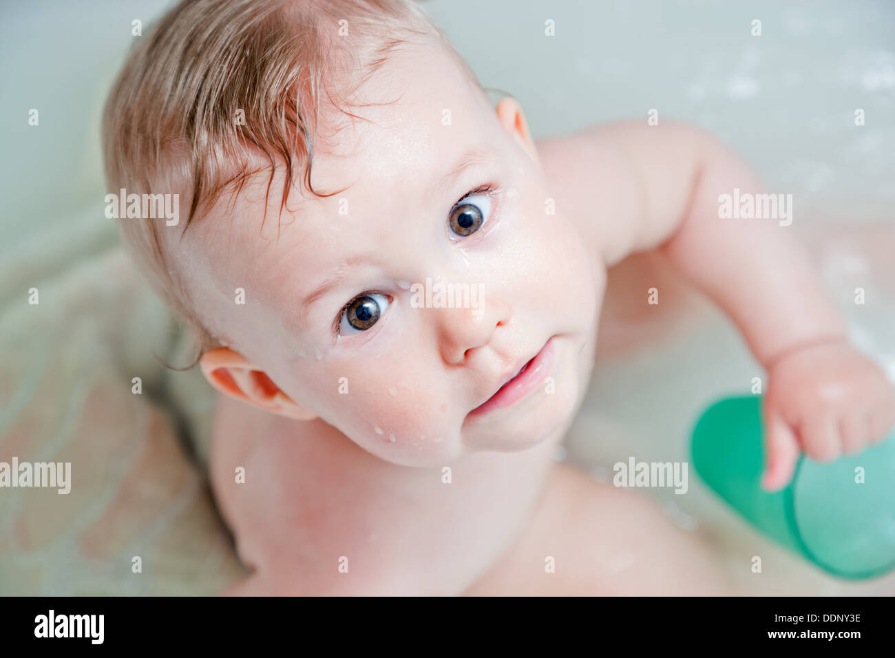 Cute happy baby having a bath Stock Photo