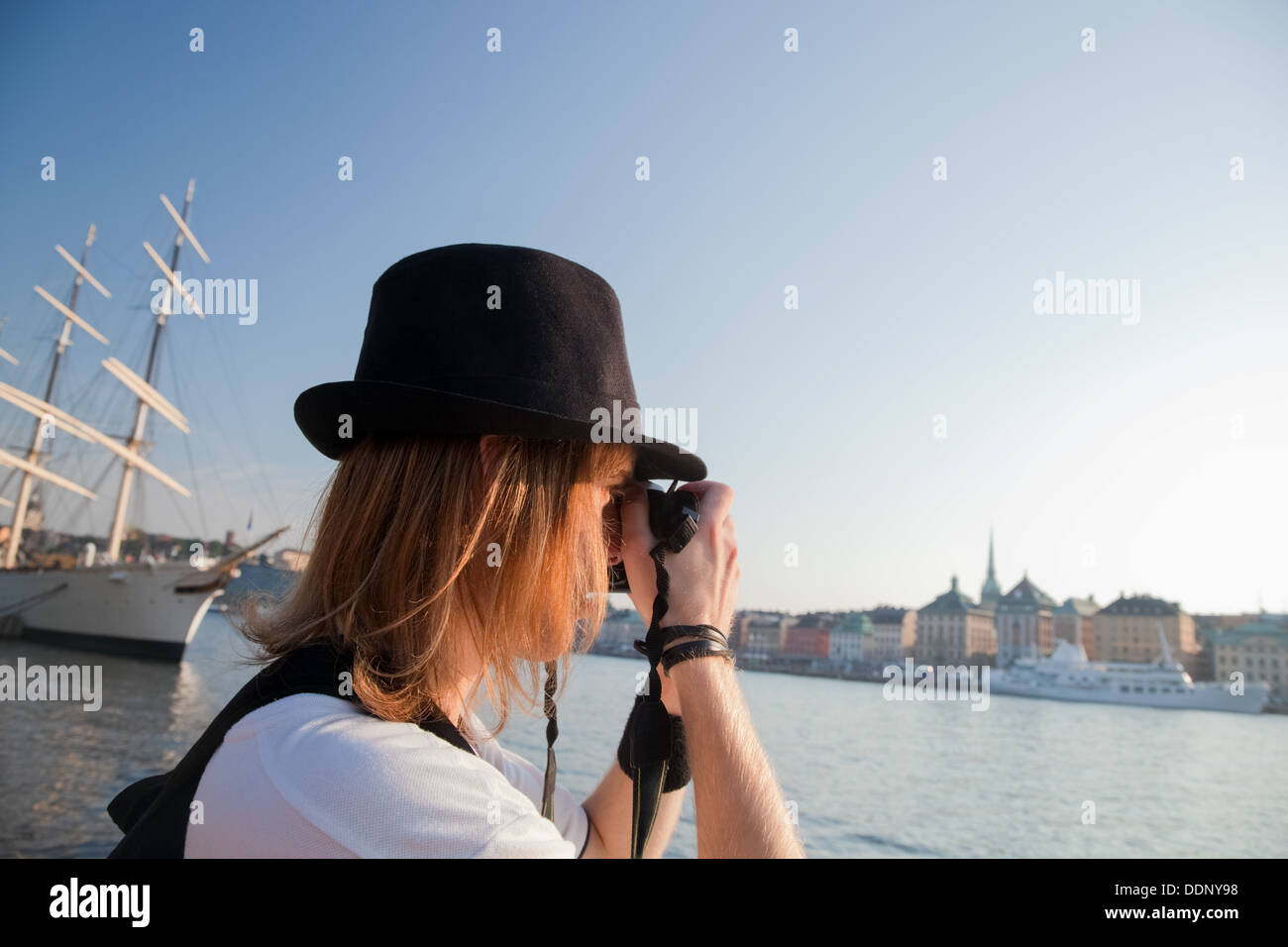 A photographer taking photographs of the waterfront in Stockholm, Sweden Stock Photo