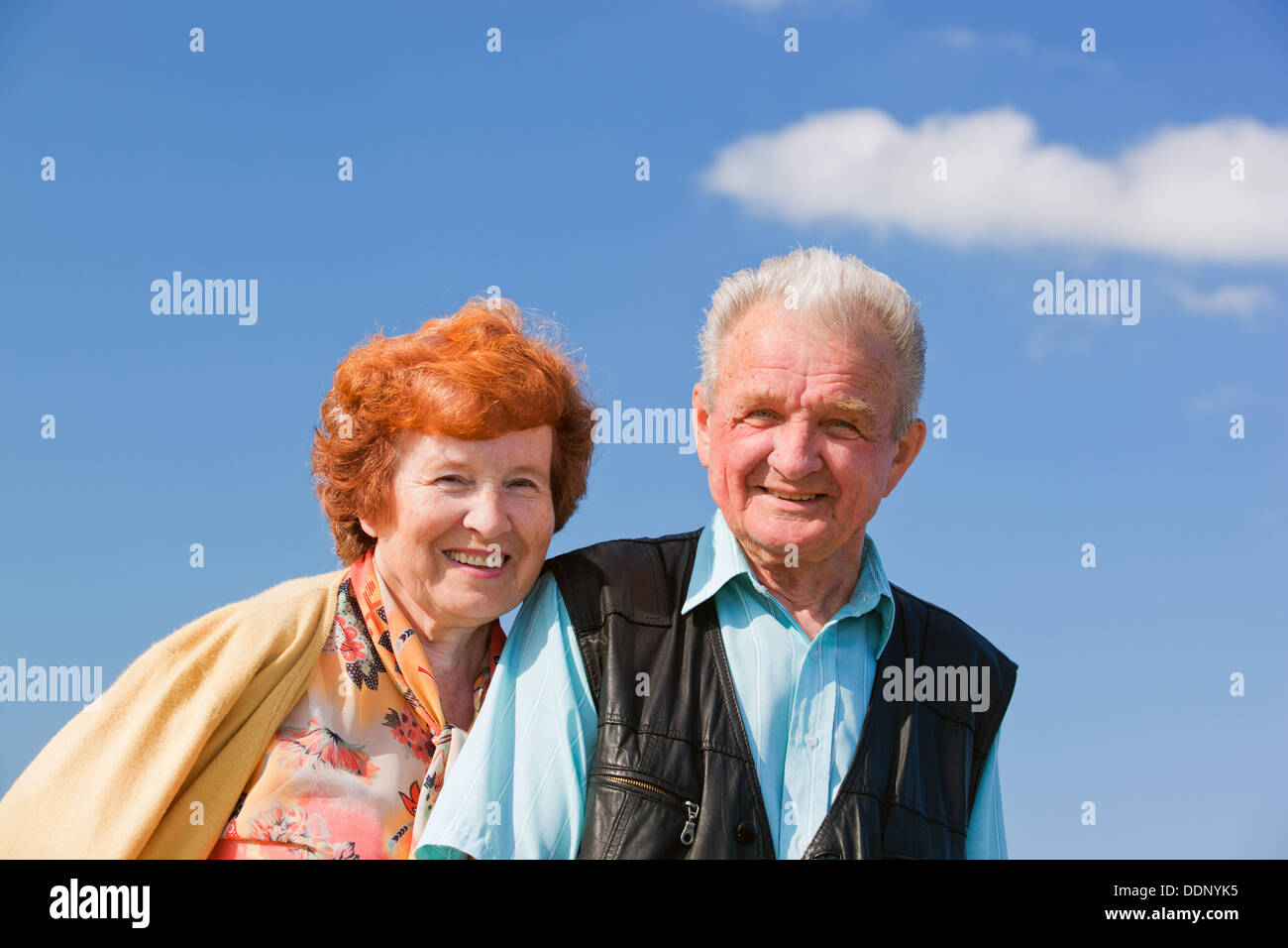 Happy senior couple together outside posing for a photograph Stock Photo
