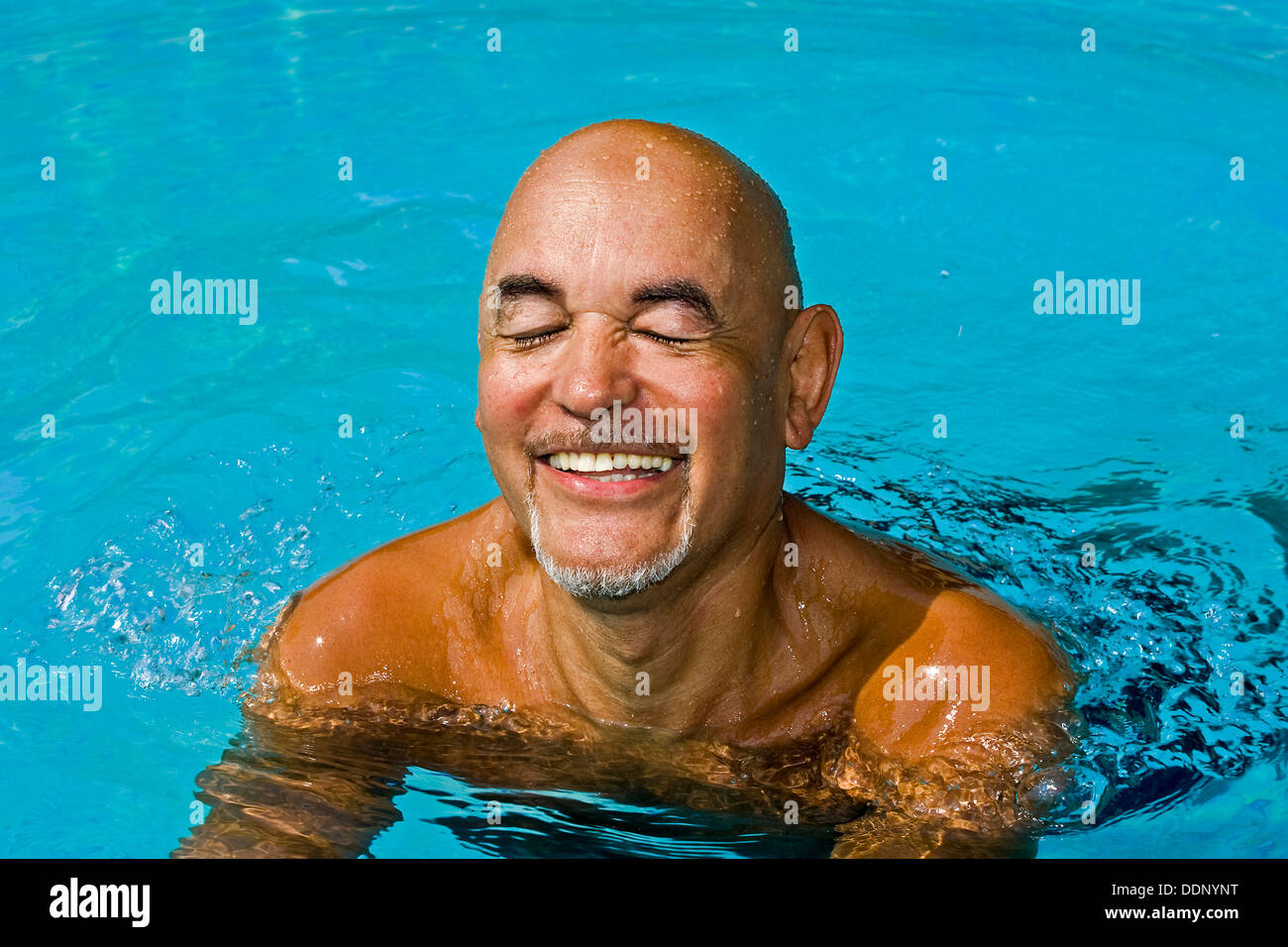 Good-humored senior citizen swimming Stock Photo