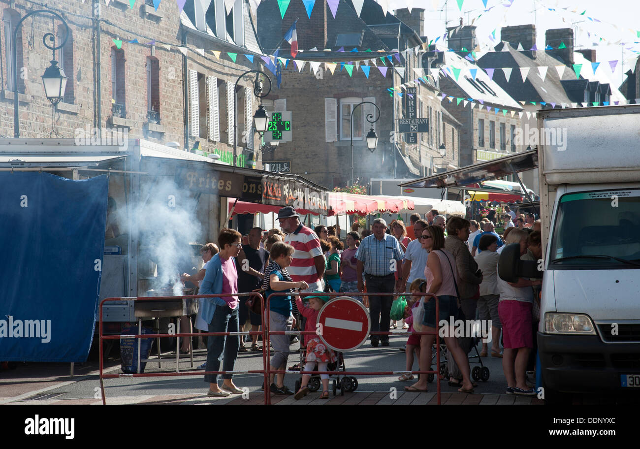 Weekly street market selling a variety of goods and food in Ducey town centre Normandy France Stock Photo