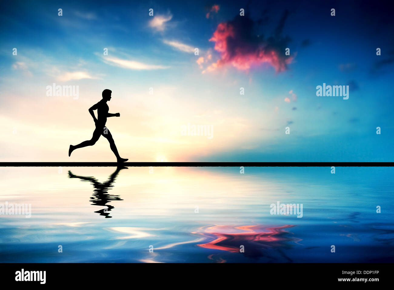 Silhouette of man running at sunset by water Stock Photo