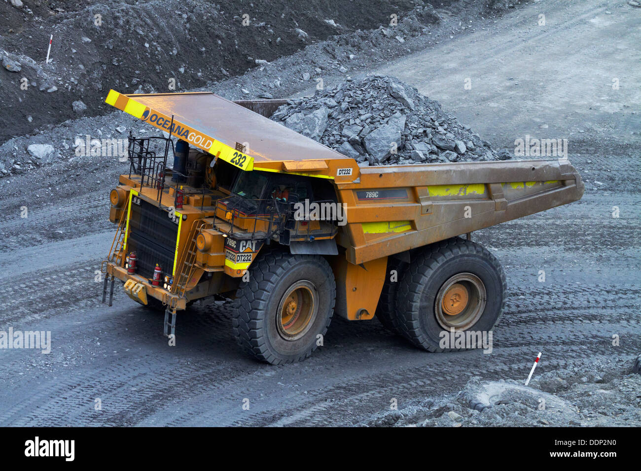 Giant dump truck at Macraes open pit gold mine, Macraes Flat, near Palmerston, East Otago, South Island, New Zealand Stock Photo