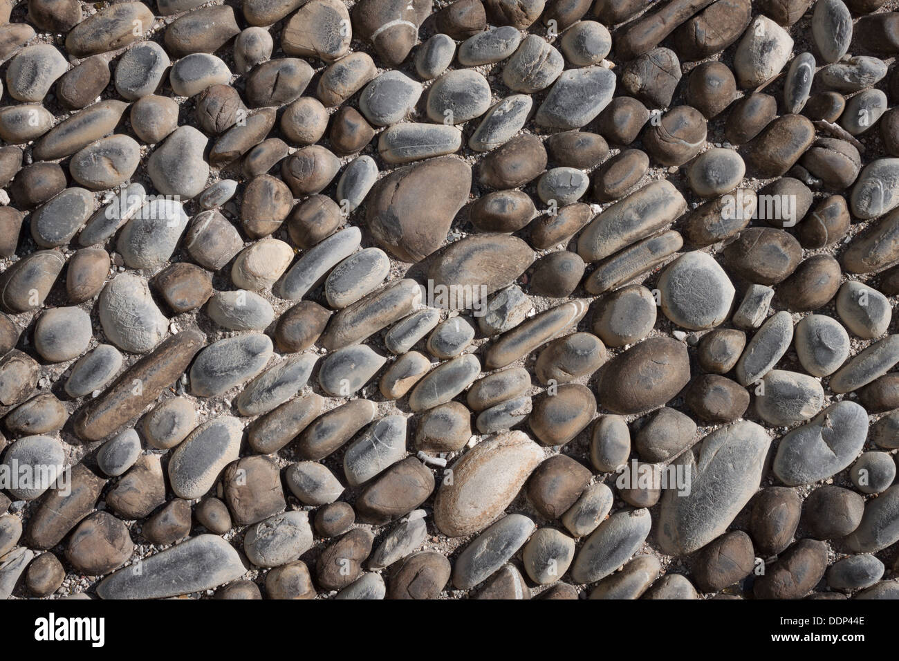 Smooth and rounded stones texture background Stock Photo - Alamy