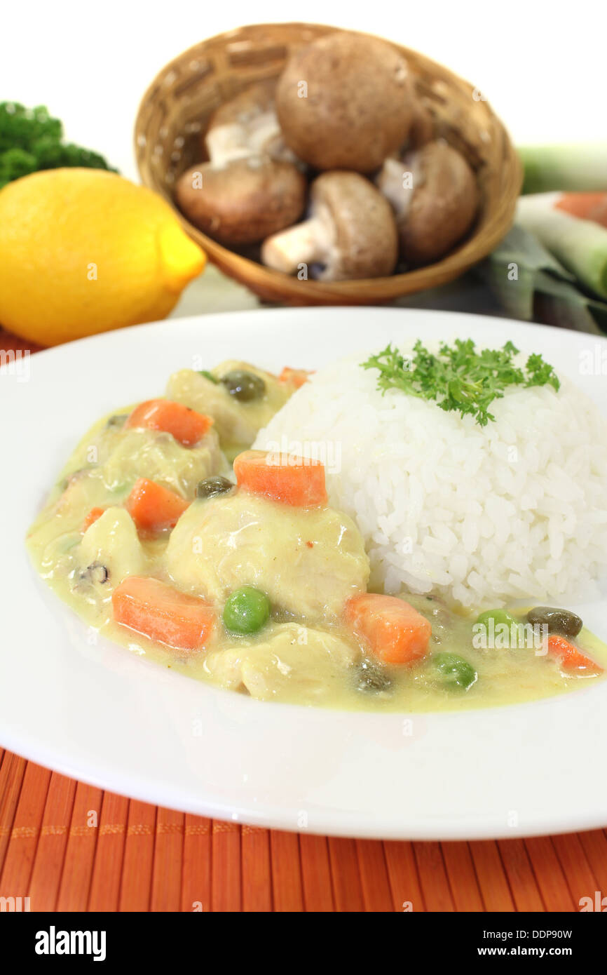 Chicken fricassee with rice, capers and parsley on a light background