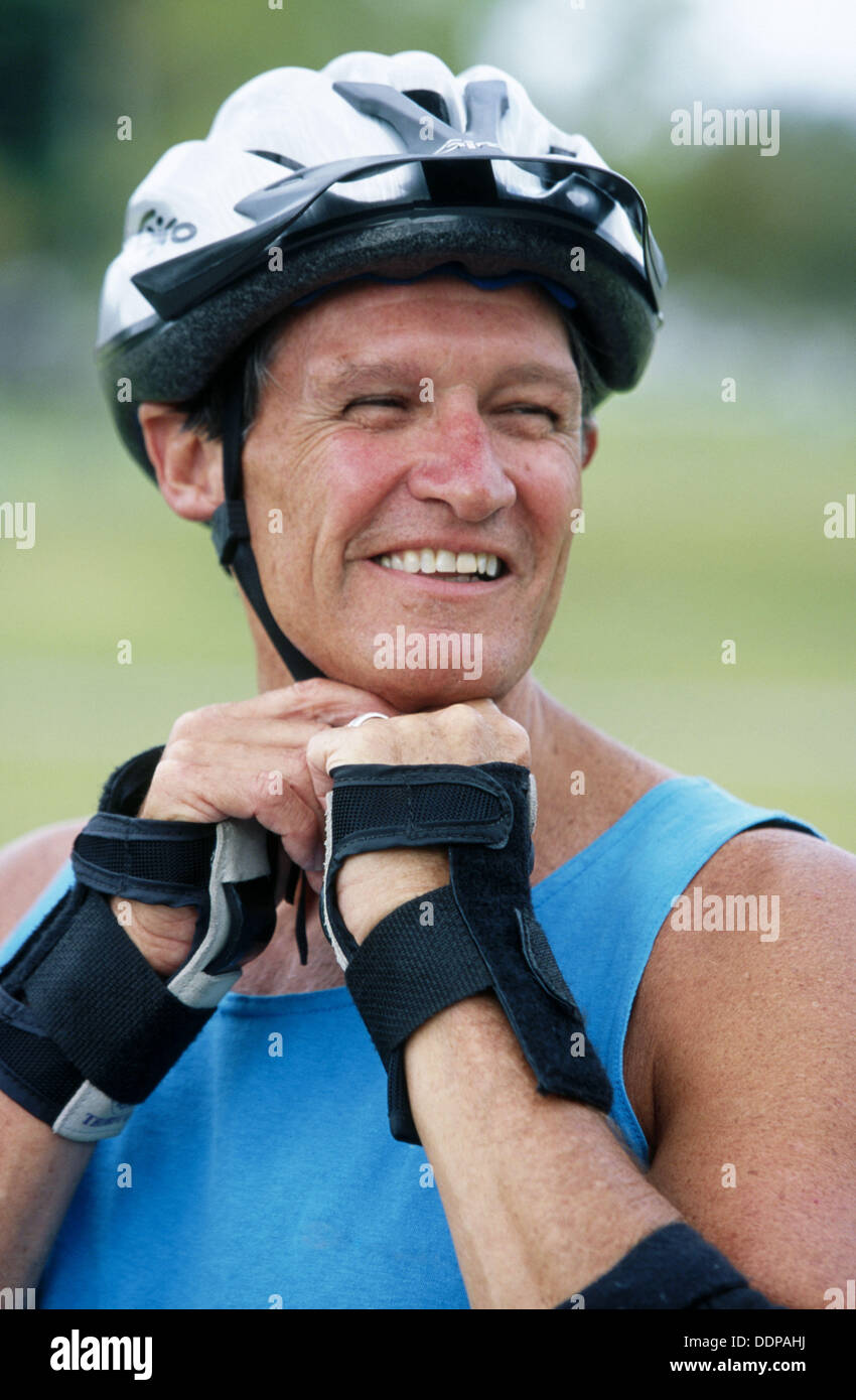 putting on his bicycle helmet Stock Photo Alamy