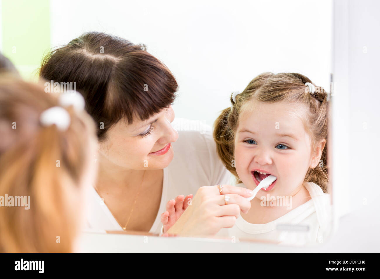 mother brushing teeth her kid Stock Photo