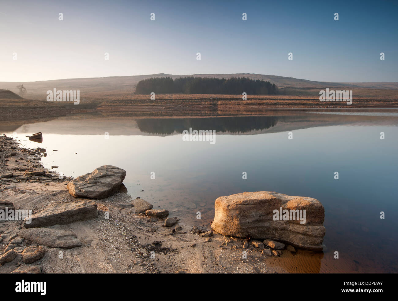 The banks of a normally full Yorkshire Moorland reservoir lye exposed during a long summer drought which has caused drinking wat Stock Photo
