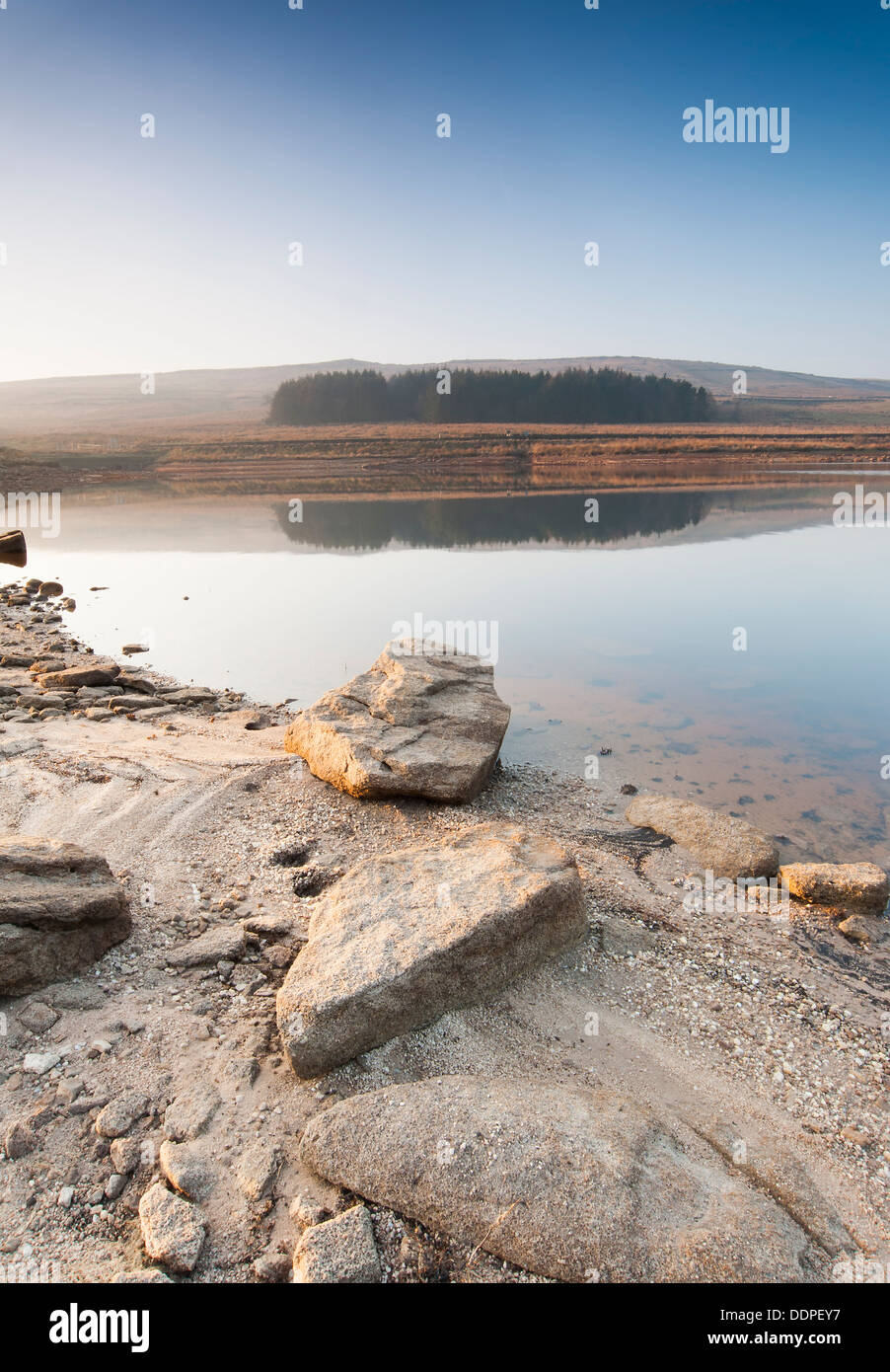 The banks of a normally full Yorkshire Moorland reservoir lye exposed during a long summer drought which has caused drinking wat Stock Photo