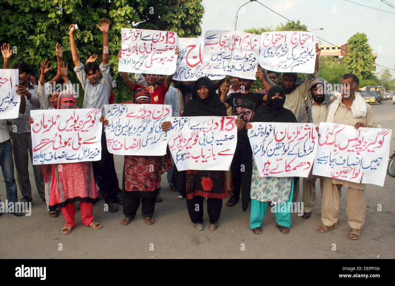 Residents of District Okara chant slogans against kidnapping of their relative Safia Bibi and demanding for her recovery during protest demonstration at Lahore press club on Thursday, September 05, 2013. Stock Photo