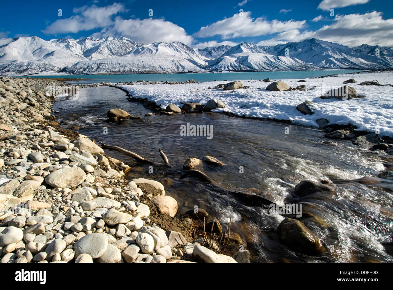 River flowing into Lake Pukaki after overnight snow down to lake level. South Island,New Zealand Stock Photo
