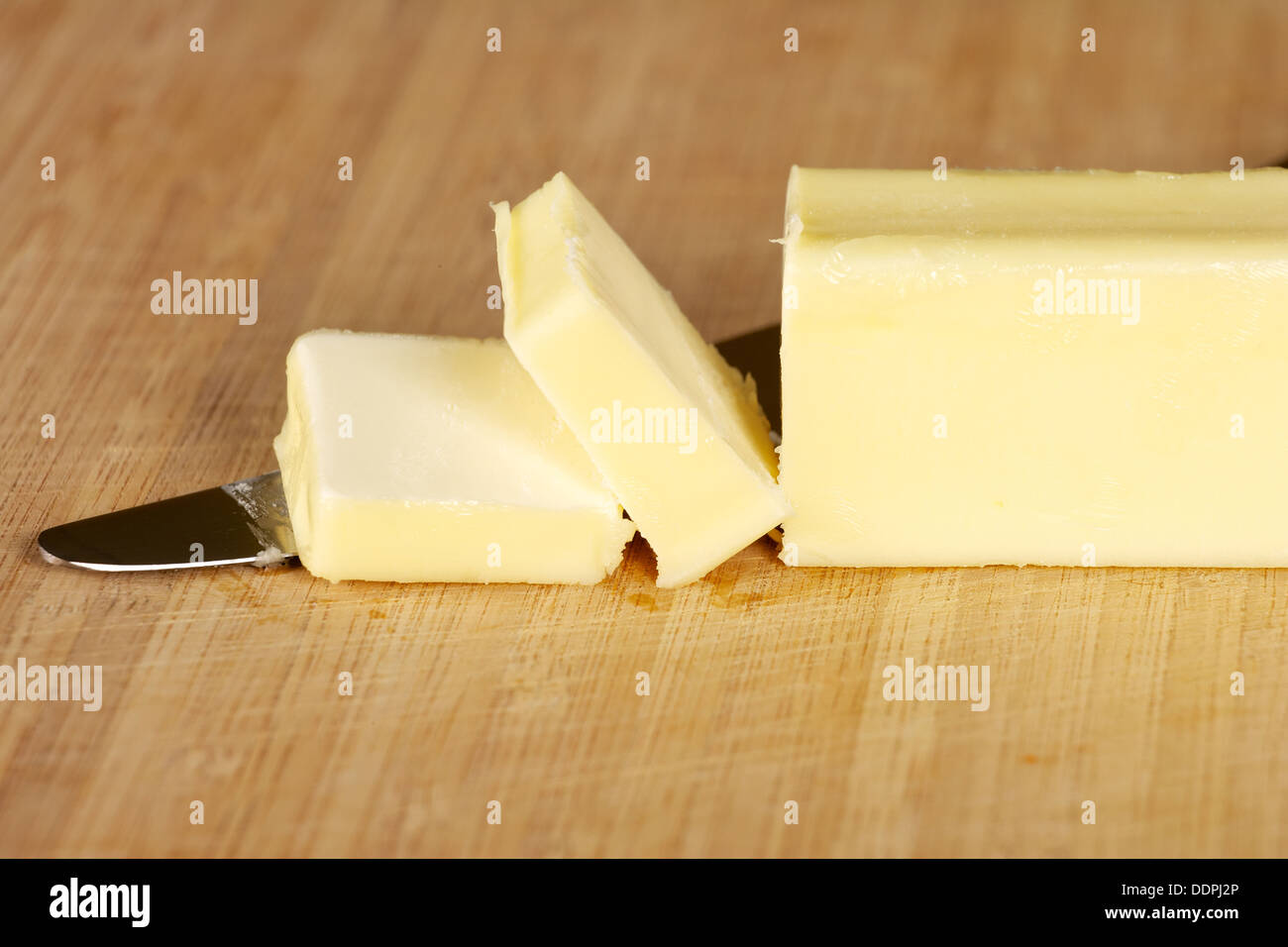 Stick of table butter on cutting board with knife Stock Photo Alamy