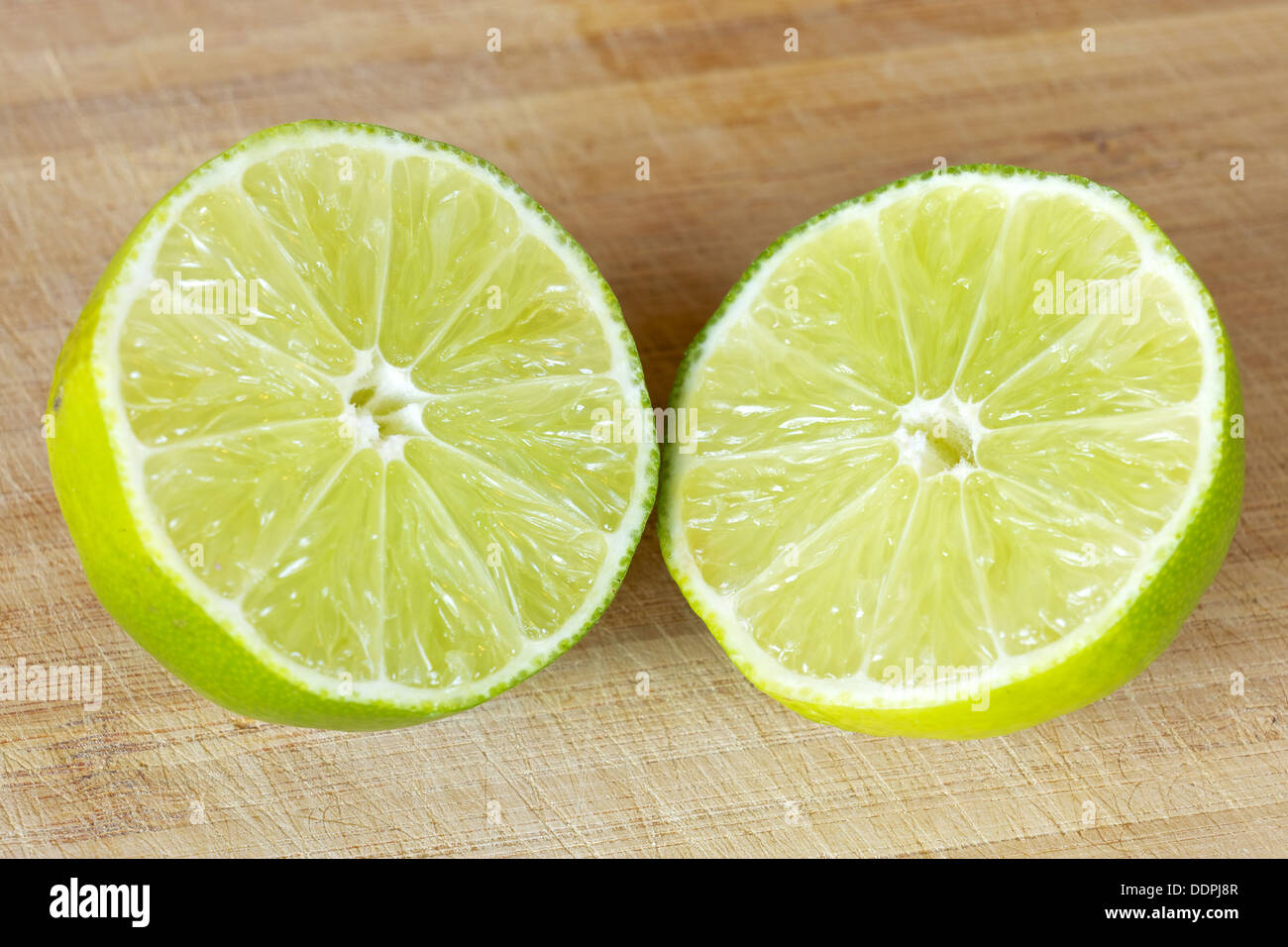 Lime slice open on a cutting board Stock Photo