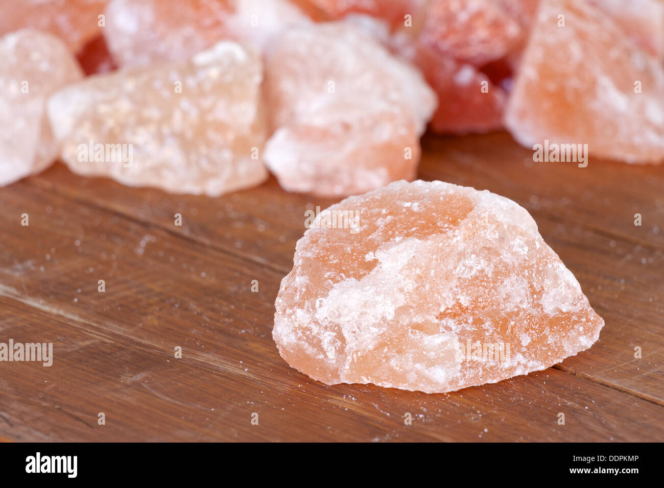 Himalayan rock salt displayed on a wood box Stock Photo