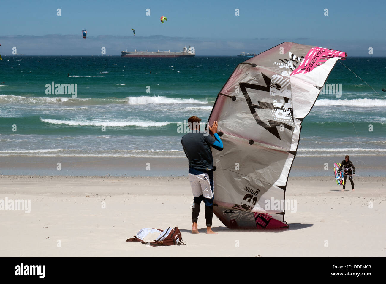 Kitesurfer prepares his kite on a beach close to Cape Town South Africa