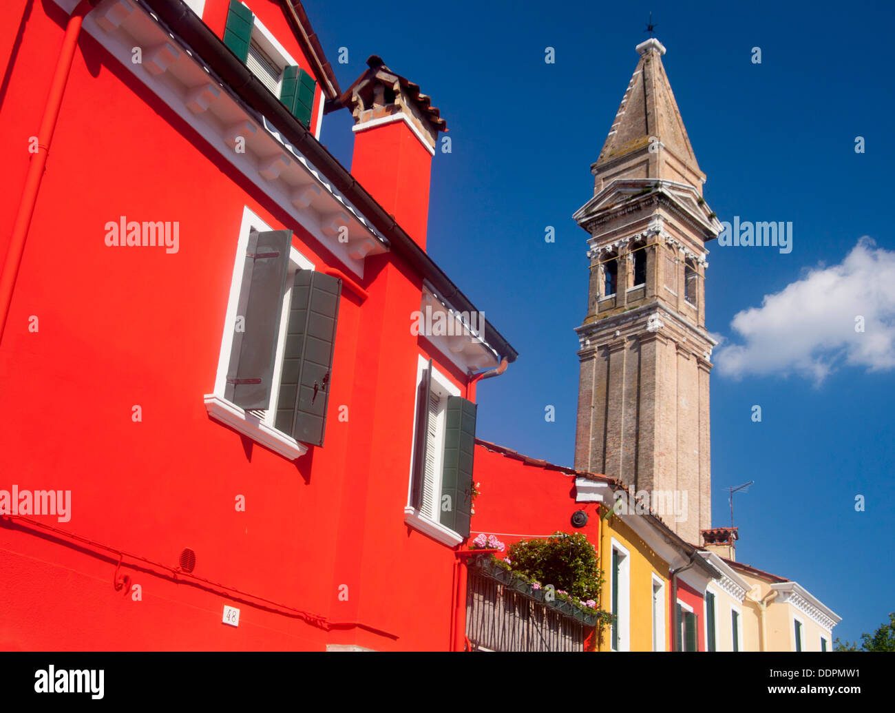 Burano Red vivid brightly painted house and leaning tower of San Martino church Venetian lagoon Venice Veneto Italy Stock Photo
