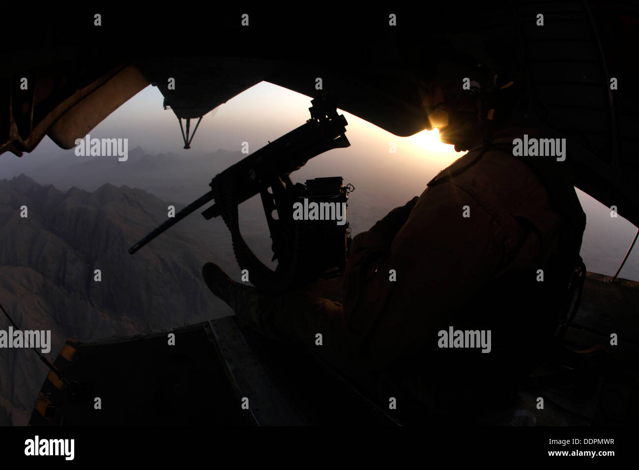 U.S. Marine Corps Cpl. Ryan P. Wells, a crew chief with Marine Heavy Helicopter Squadron 462 (HMH-462), provides aerial security over Helmand province, Afghanistan, Aug. 31, 2013. HMH-462 transported Marines with Golf Company, 2nd Battalion, 8th Marines, Stock Photo