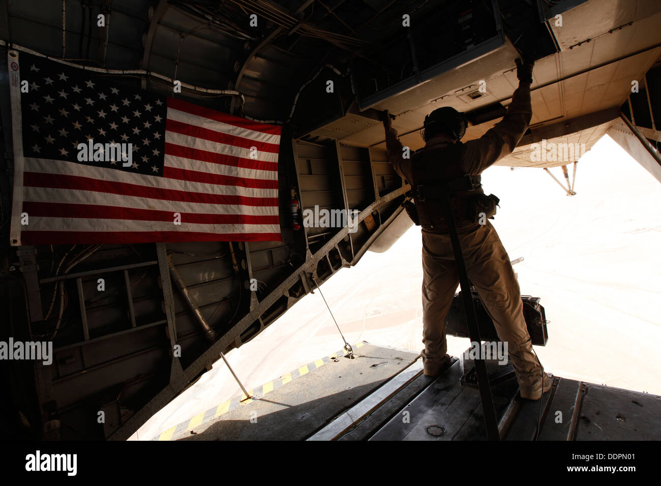 U.S. Marine Corps Cpl. Ryan P. Wells, a crew chief with Marine Heavy Helicopter Squadron 462 (HMH-462), provides aerial security over Helmand province, Afghanistan, Aug. 31, 2013. HMH-462 transported Marines with Golf Company, 2nd Battalion, 8th Marines, Stock Photo