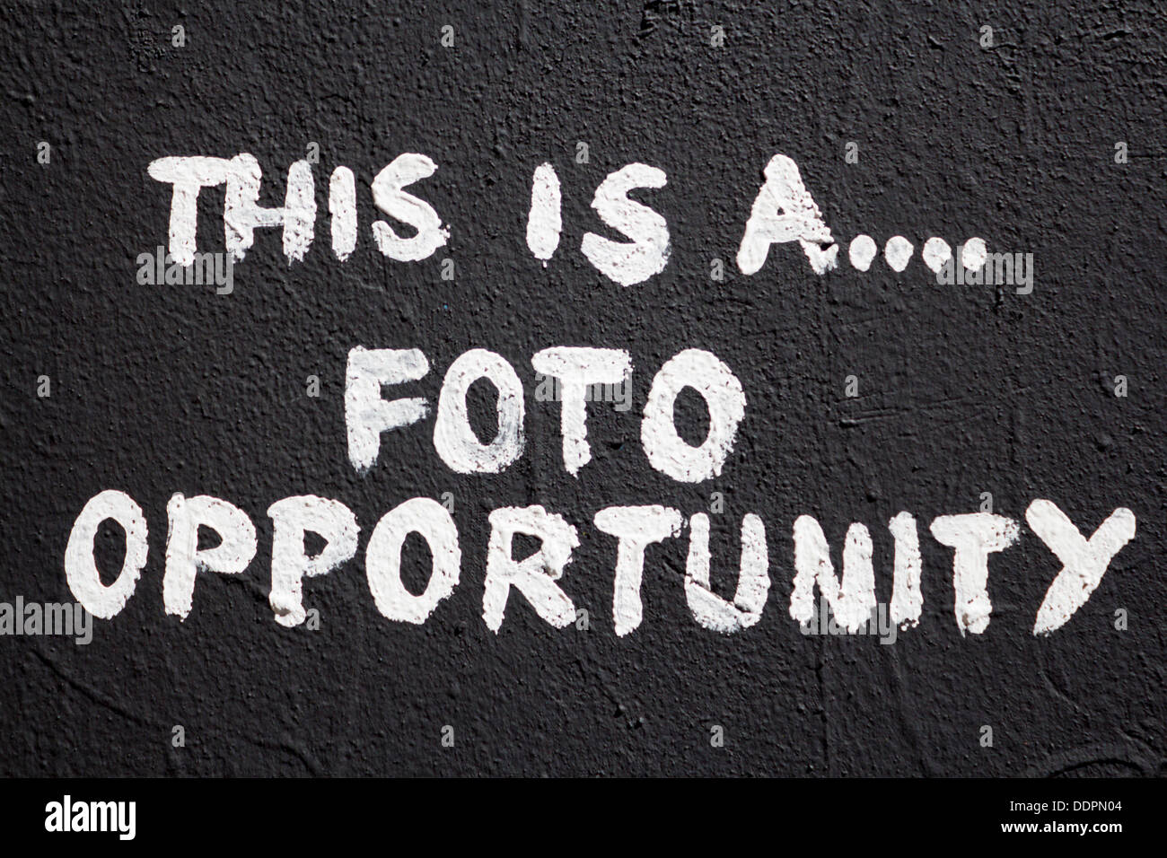 'This is a foto photo opportunity' artwork mural graffiti on wall Berlin Germany Stock Photo