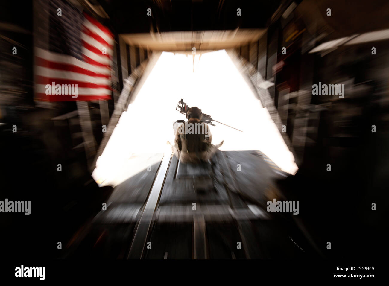U.S. Marine Corps Cpl. Ryan P. Wells, a crew chief with Marine Heavy Helicopter Squadron 462 (HMH-462), provides aerial security over Helmand province, Afghanistan, Aug. 31, 2013. HMH-462 transported Marines with Golf Company, 2nd Battalion, 8th Marines, Stock Photo
