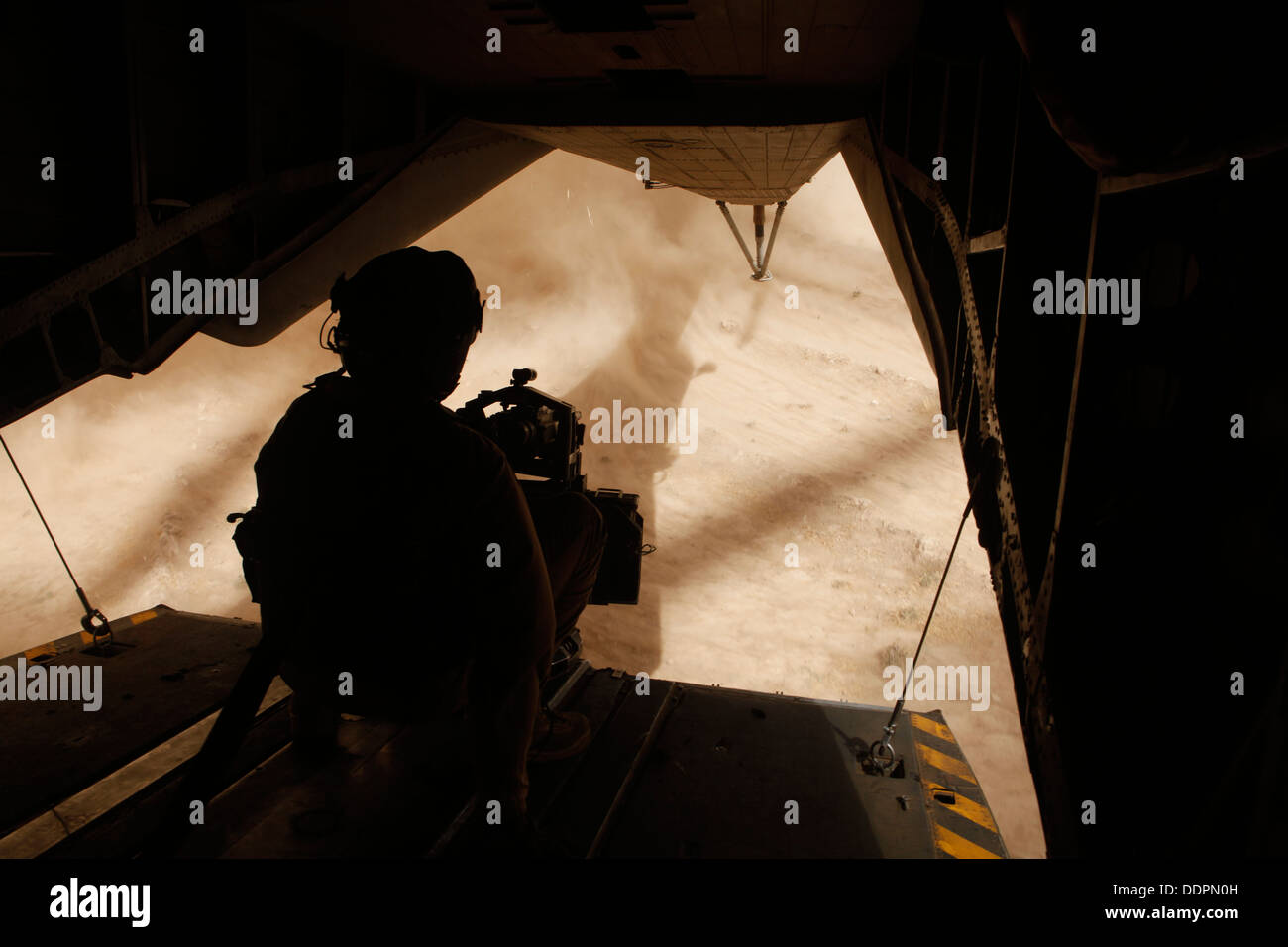 U.S. Marine Corps Cpl. Ryan P. Wells, a crew chief with Marine Heavy Helicopter Squadron 462 (HMH-462), provides aerial security over Helmand province, Afghanistan, Aug. 31, 2013. HMH-462 transported Marines with Golf Company, 2nd Battalion, 8th Marines, Stock Photo