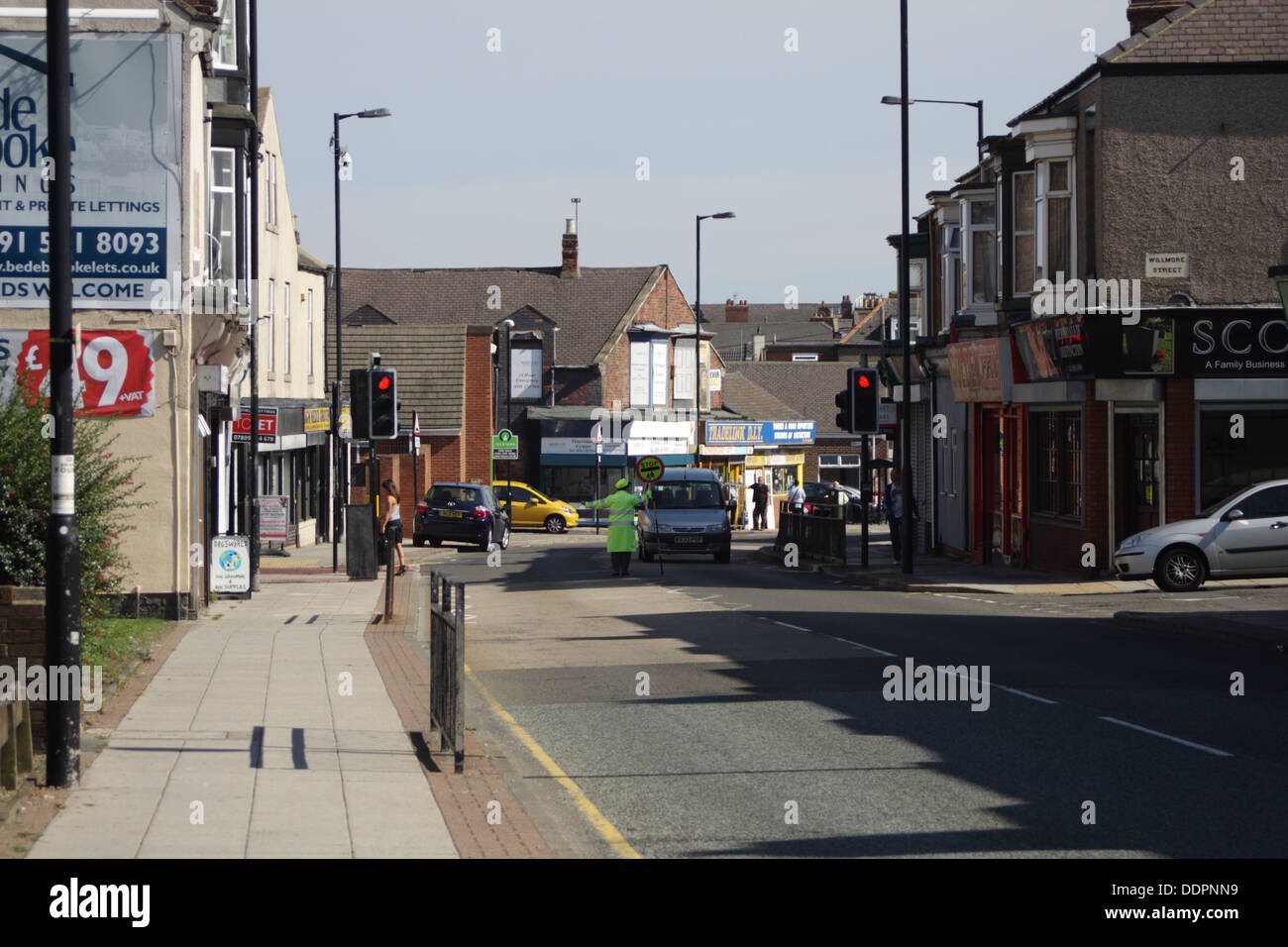 Hylton Road, A lollipop lady is stopping traffic for pedestrians who wish to cross the road. Stock Photo