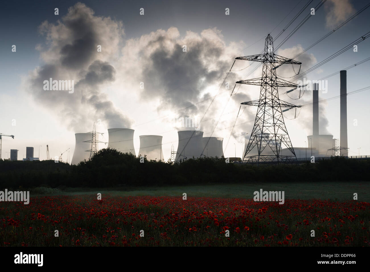 Ferrybridge C coal fired power station in West Yorkshire, with a field of red poppies in the foreground. Stock Photo