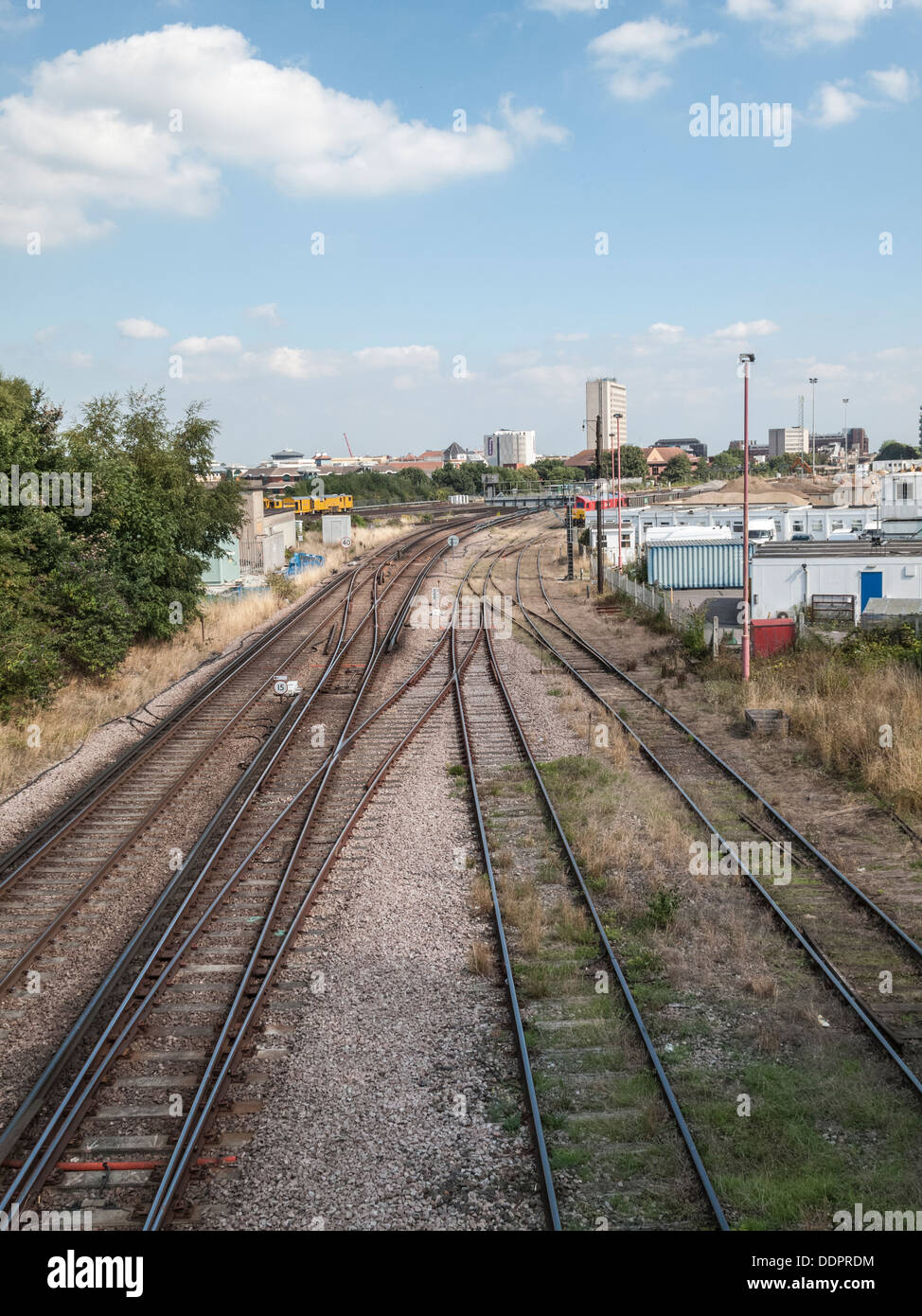 Railway tracks leading towards Woking, Surrey, England and Woking station Stock Photo