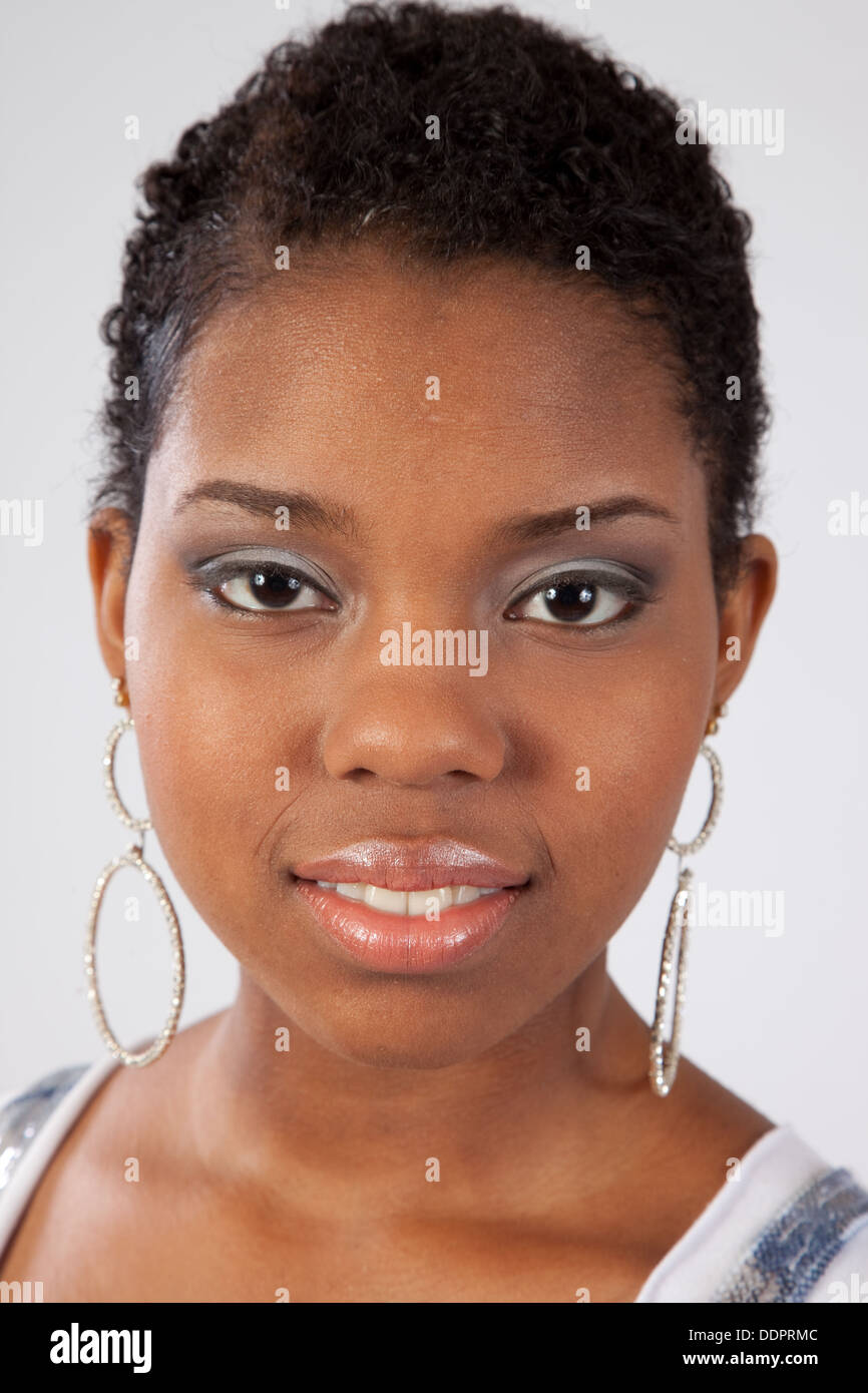Pretty black woman looking at the camera with a friendly, pleasing ...