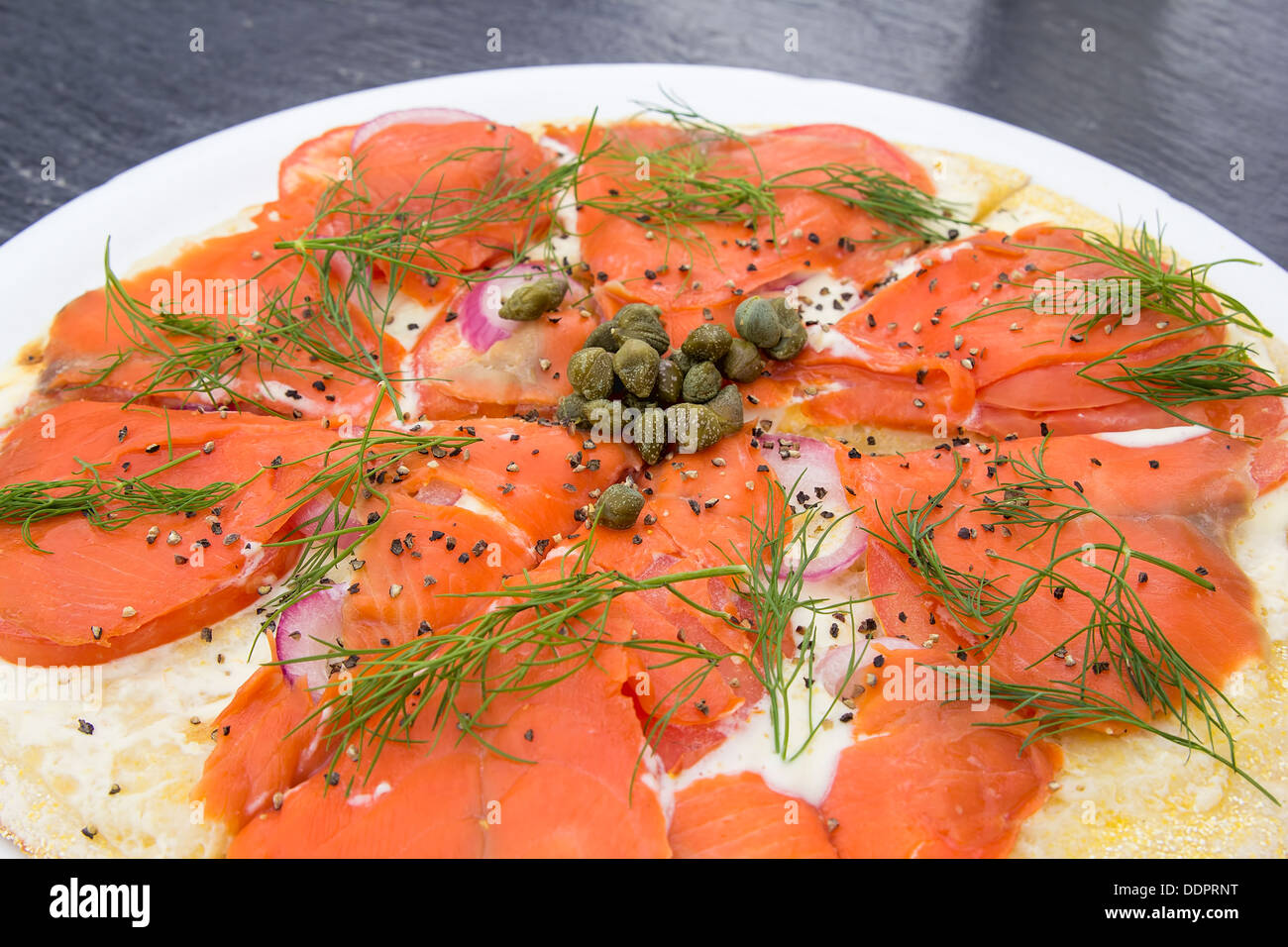 Smoked Salmon Pizza Topped with Capers Dill Cream Cheese Onion Tomato