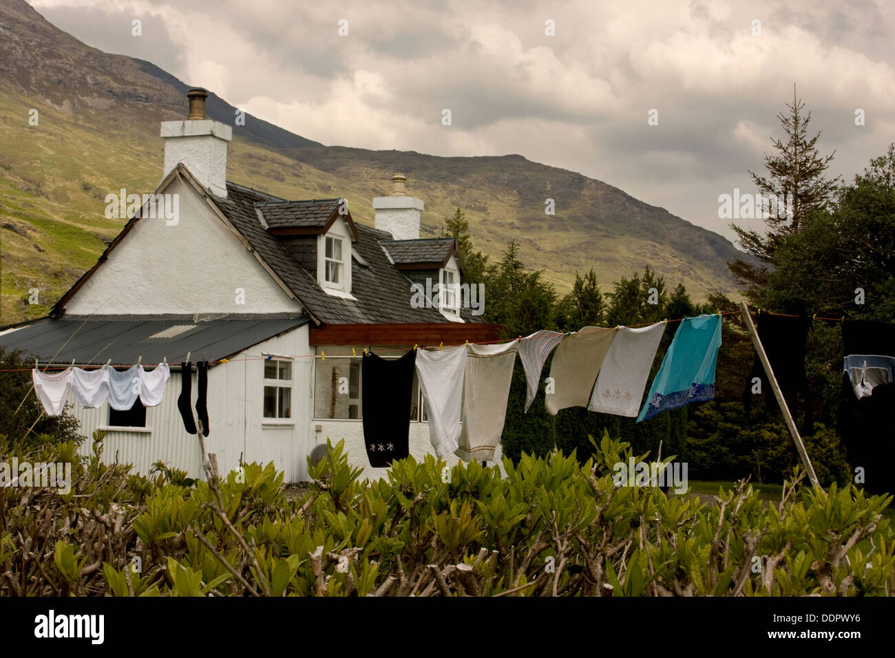 White cottage with washing on line on cloudy day, Isle of Mull, Scotland Stock Photo