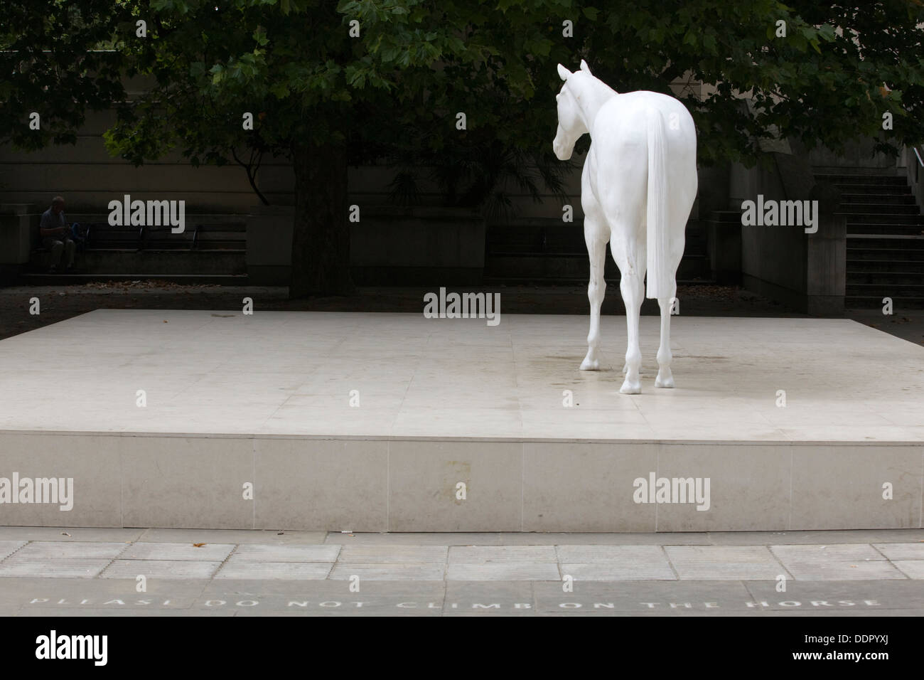White Horse Statue with "Please don not climb on the Horse" on the pavement Stock Photo Alamy