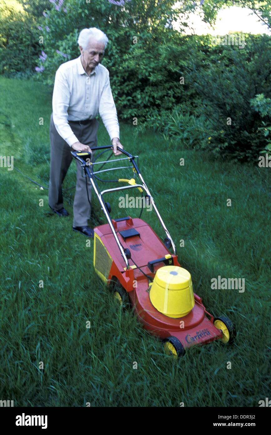 Senior man pushing a lawnmower Stock Photo Alamy