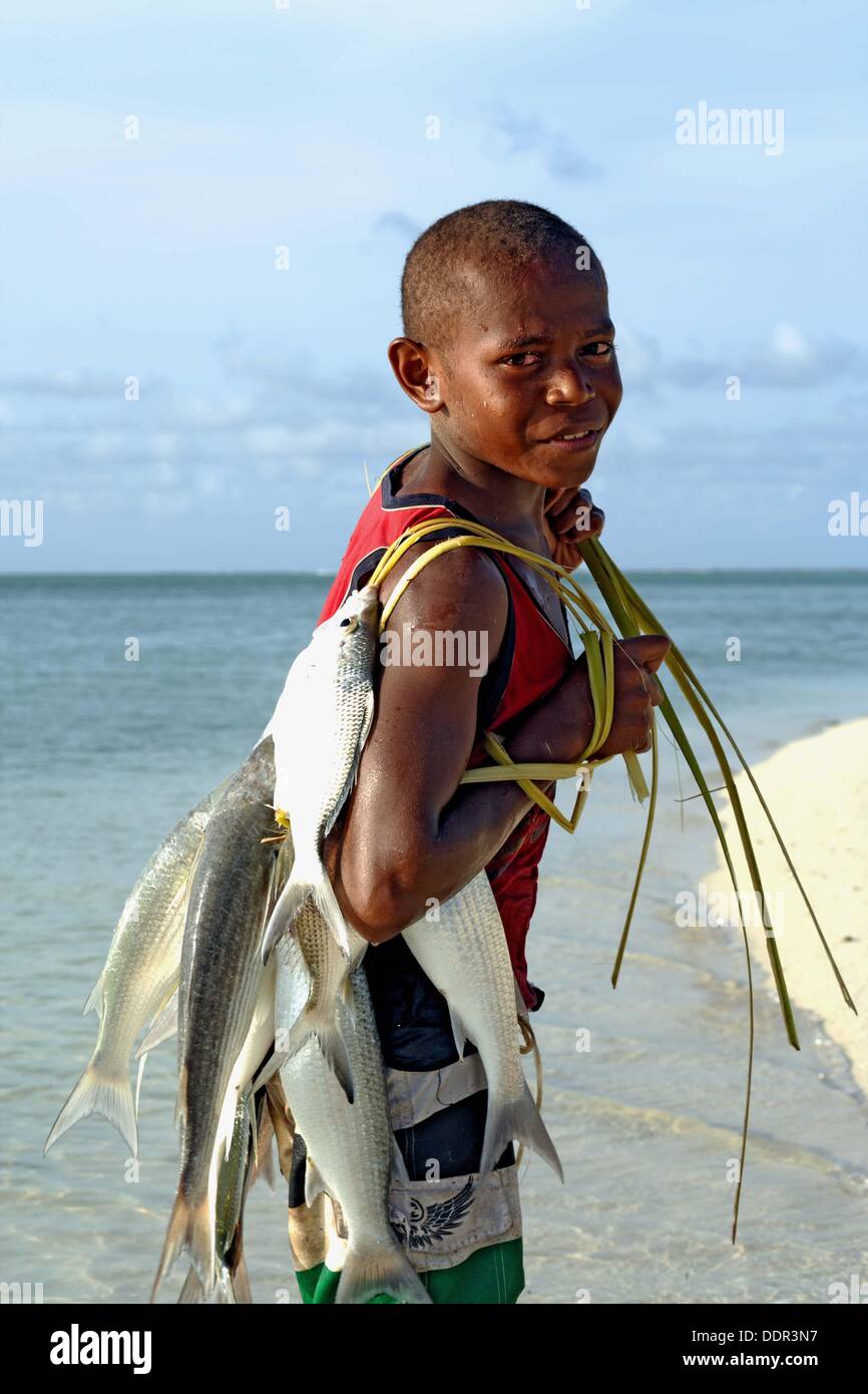 Young melanesian boy at the deserted beach of the Reef Islands Atoll