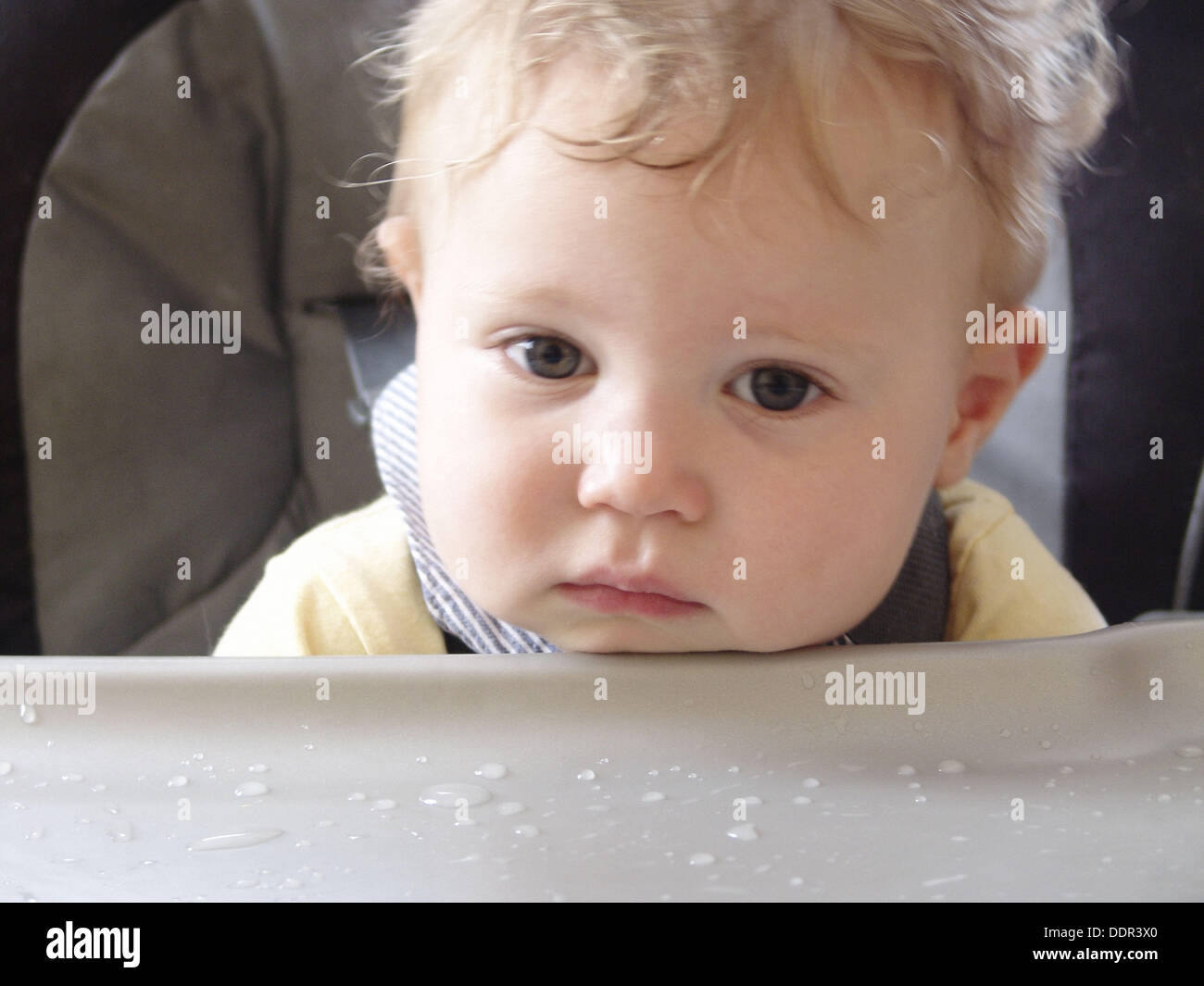 Tired one year old boy after eating Stock Photo Alamy