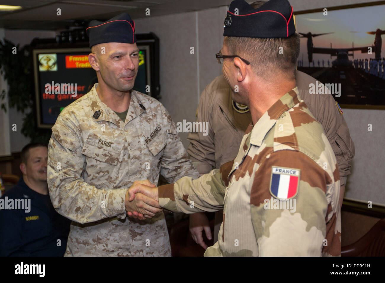 U.S. Marine Corps Sgt. Maj. Todd M. Parisi, 26th Marine Expeditionary Unit sergeant major, receives a cover from French Marine L Stock Photo