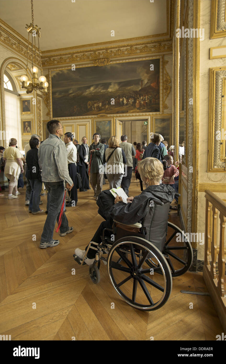 Tourist in a wheelchair visiting State Apartments. Chateau of