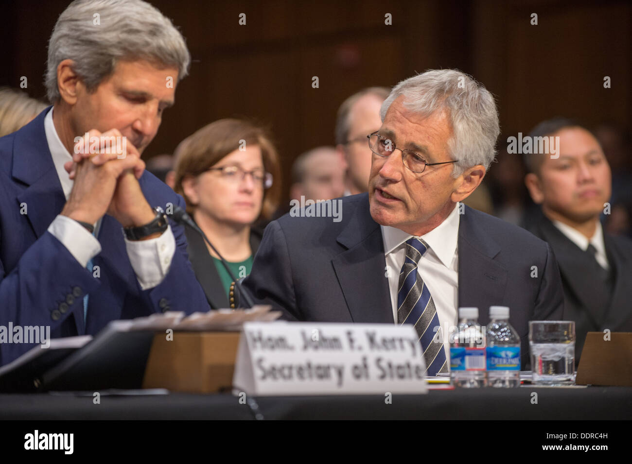 Secretary of Defense Chuck Hagel speaks to Secretary of State John Kerry during a Senate Foreign Relations Committee hearing at Stock Photo