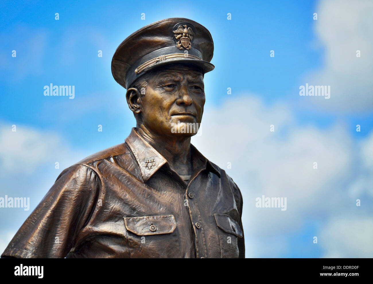 A 9-foot tall bronze statue of Fleet Adm. Chester Nimitz is unveiled at a statue dedication ceremony in front of the Battleship Stock Photo