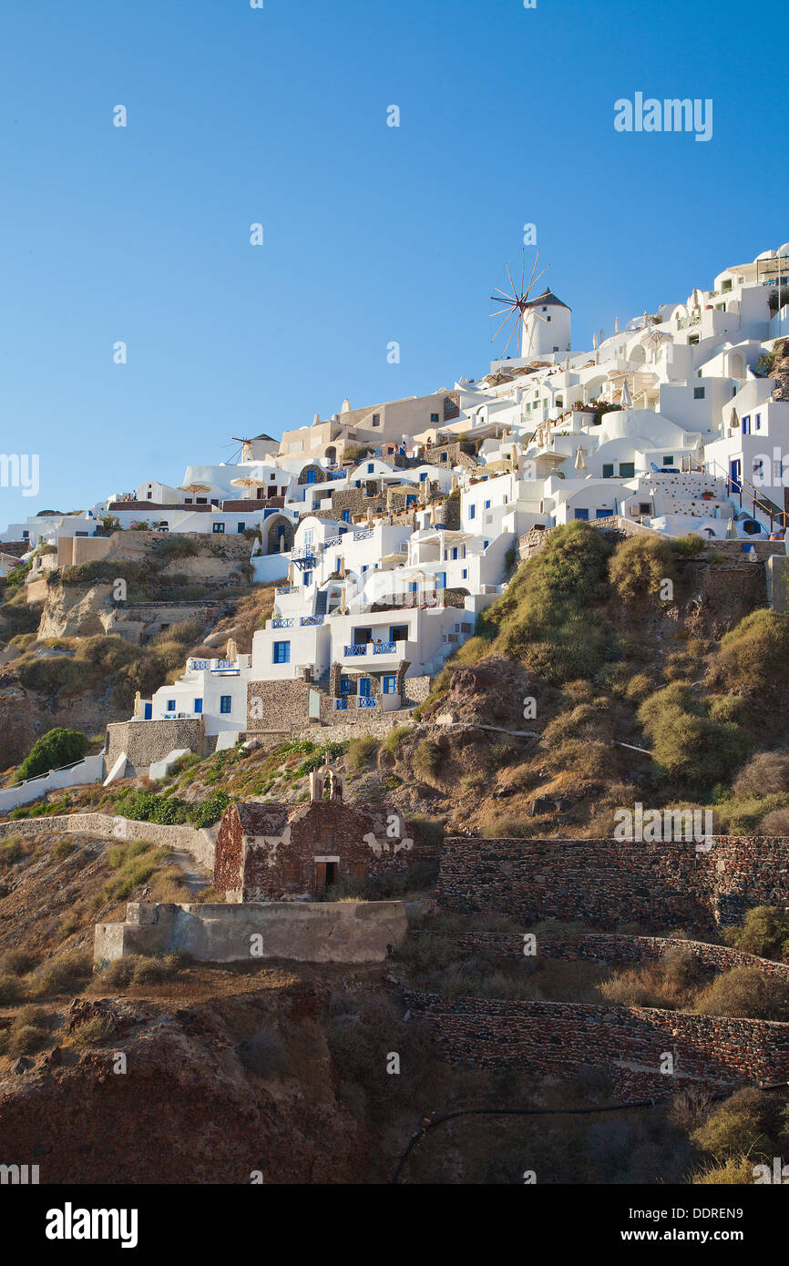 Houses built on the cliff face at Oia, Santorini, Cyclades, Greece, the northern tip of the island which leads down to Ammoudi. Stock Photo