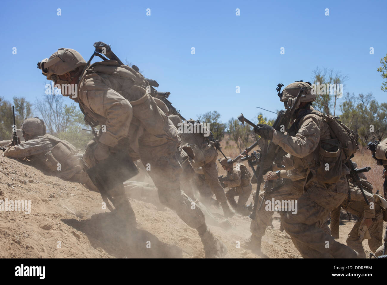 Marines with Weapons Co., Battalion Landing Team 2nd Battalion, 4th Marines, 31st Marines Expeditionary Unit, charge up a hill t Stock Photo
