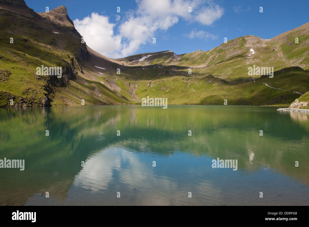 Reflections on Bachalpsee lake in the Jungfrau region, Switzerland. Stock Photo