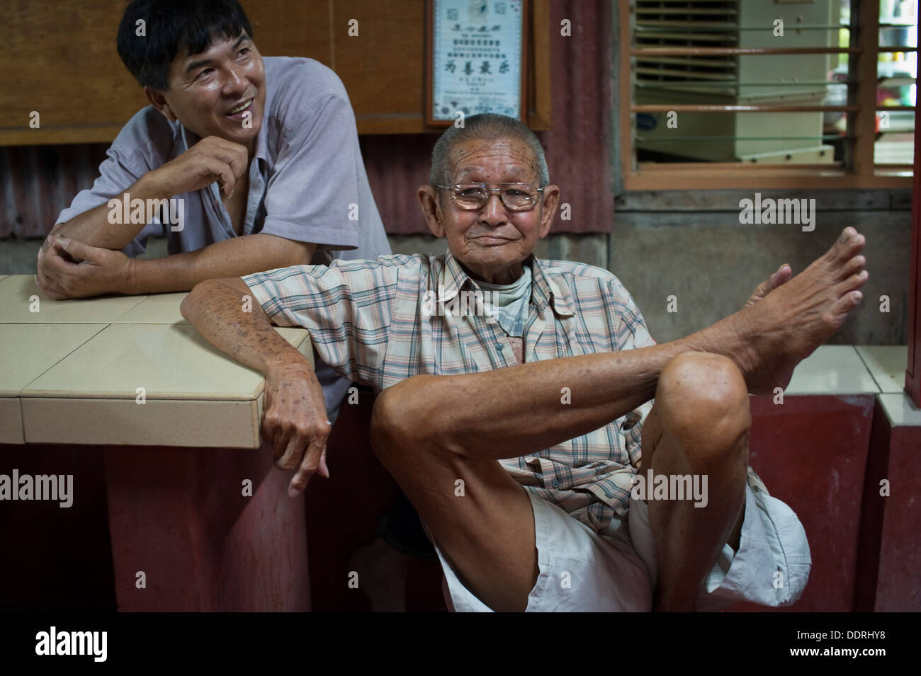 Two Chinese men in a clan village, Penang Stock Photo