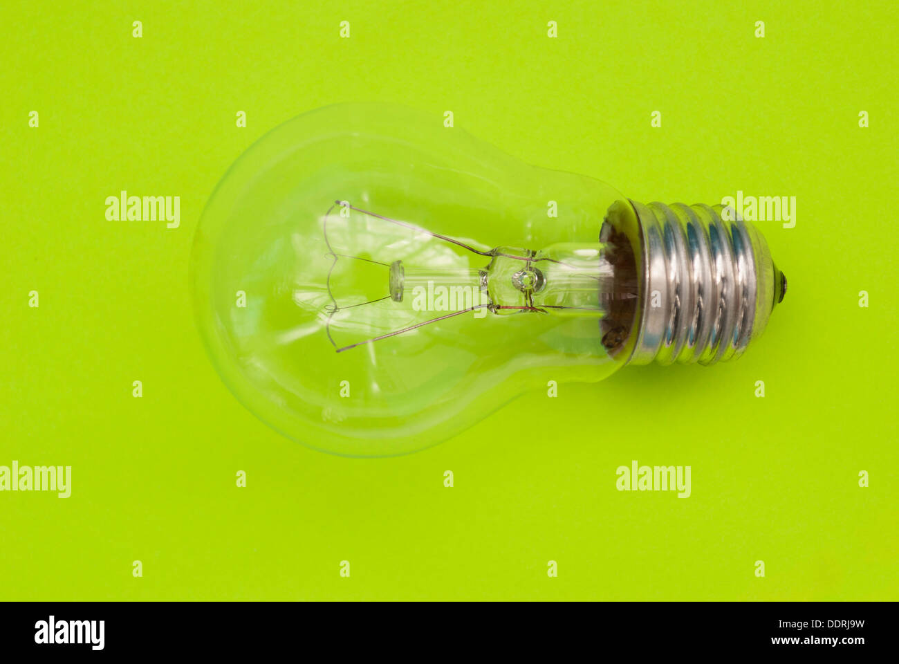 Light bulb on a green background Stock Photo - Alamy