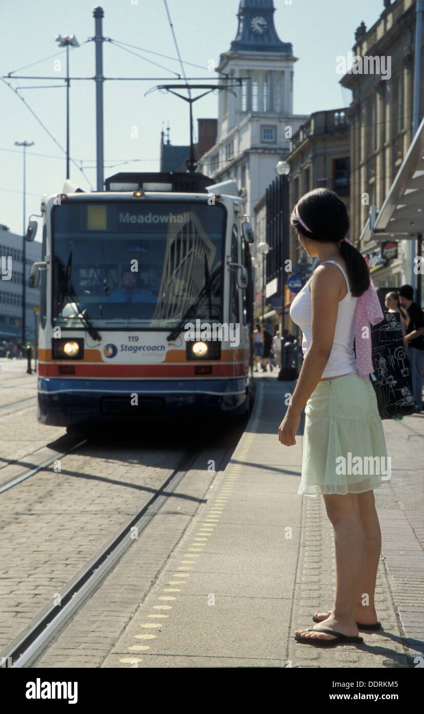 teenage girl waiting for tram, Sheffield, England Stock Photo