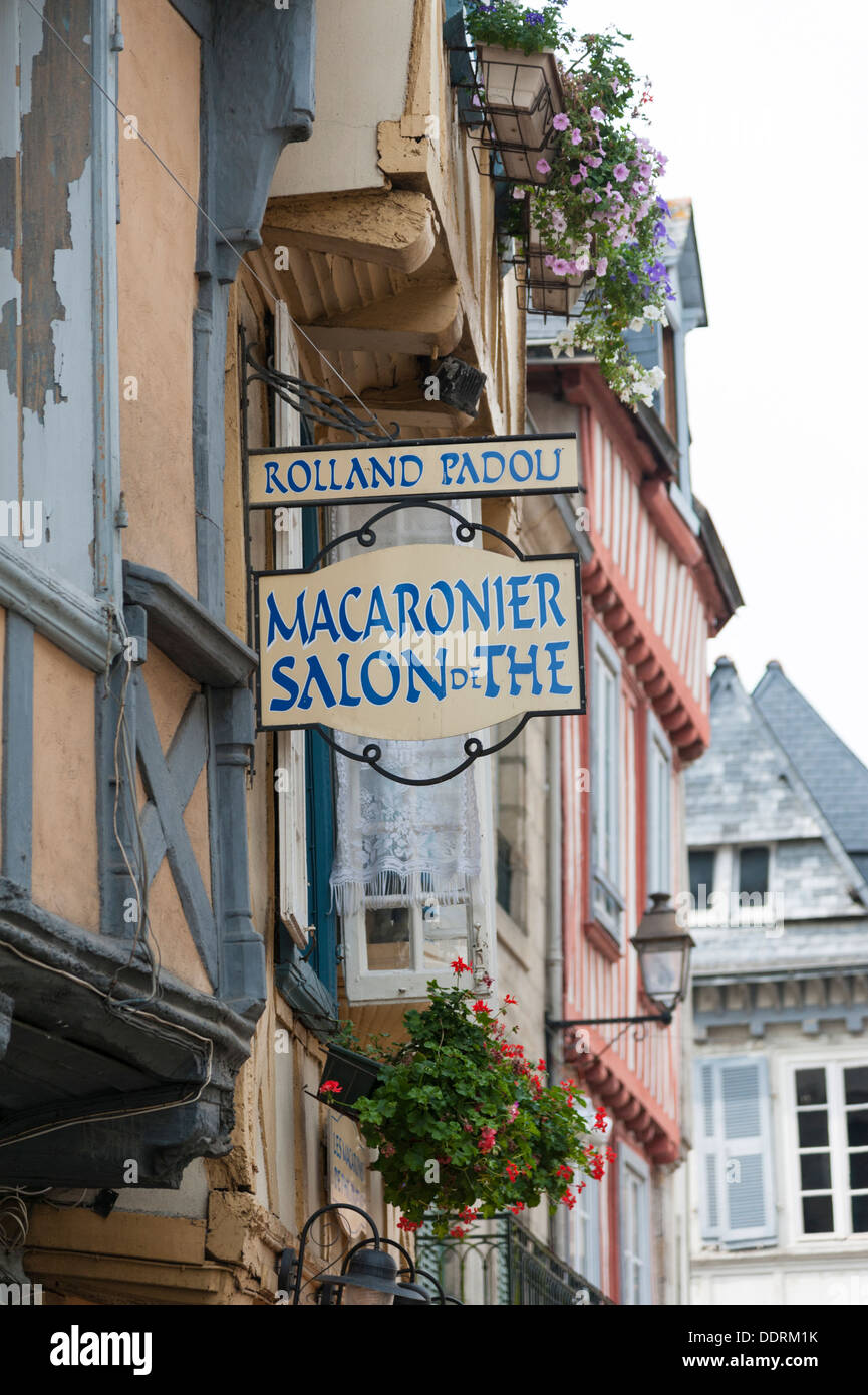 Half timbered old buildings in Quimper Brittany France with a sign for a macaronier and salon de the Stock Photo