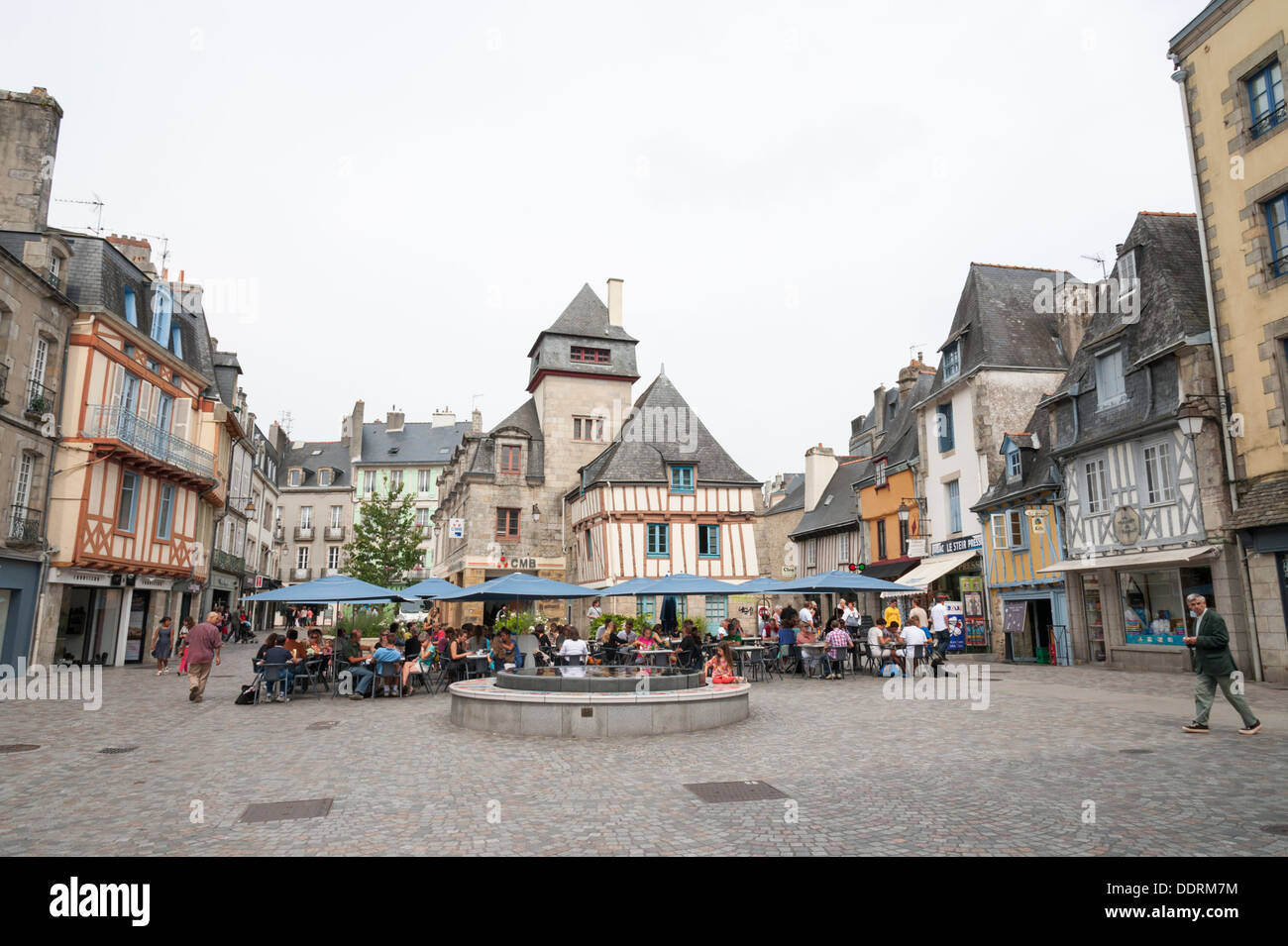Half timbered old buildings in a square in Quimper Brittany France with dining tables outside. Stock Photo